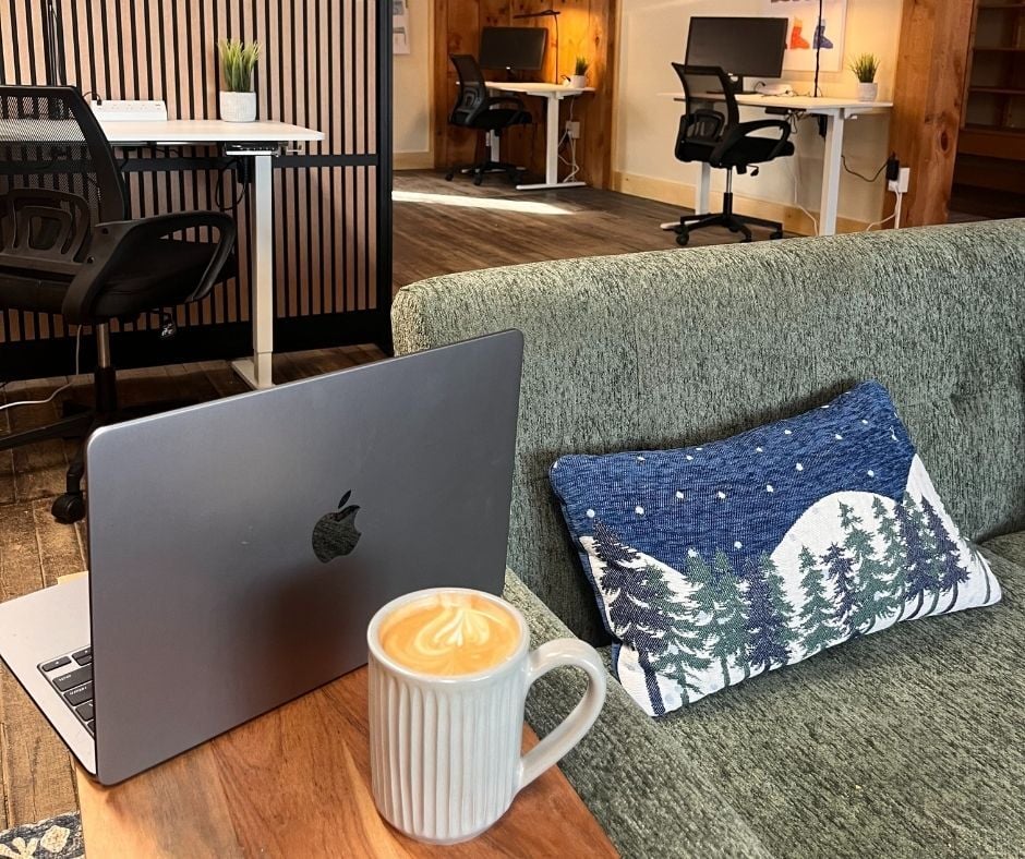 Enjoying a fresh latte in a cozy mug on the couch in the lounge at a local coworking spot in Kingfield, Maine. 