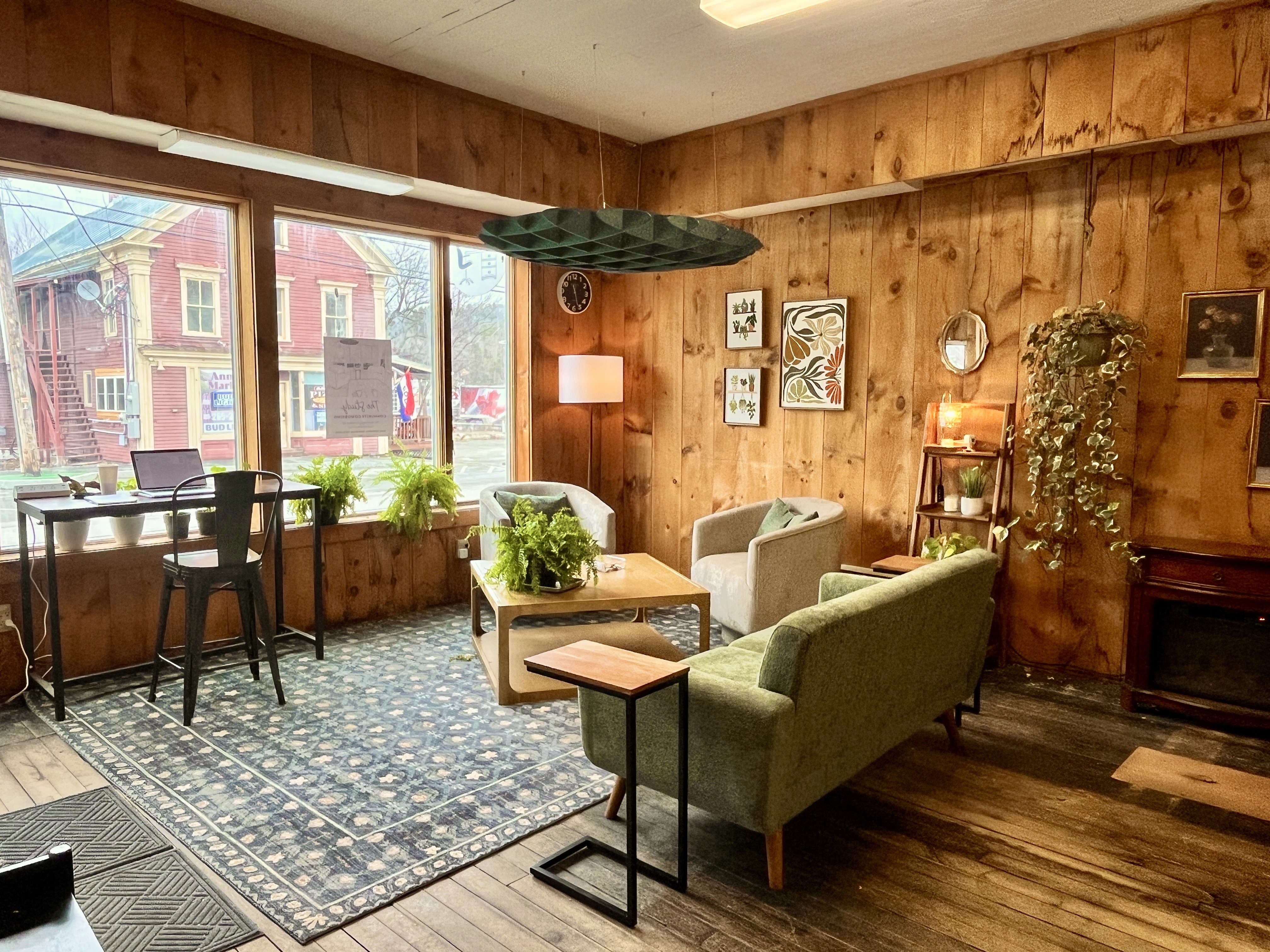 A cozy lounge for meetings in the Study Coworking space in Kingfield Maine. Full of pine planked walls and lively plants for those cozy vibes.