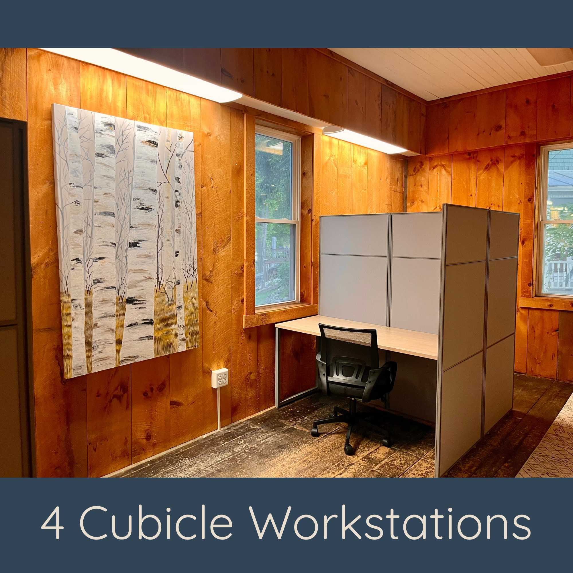 4 Cubicle Workstations: "Four private cubicle workstations with partitions in a wood-paneled coworking room"