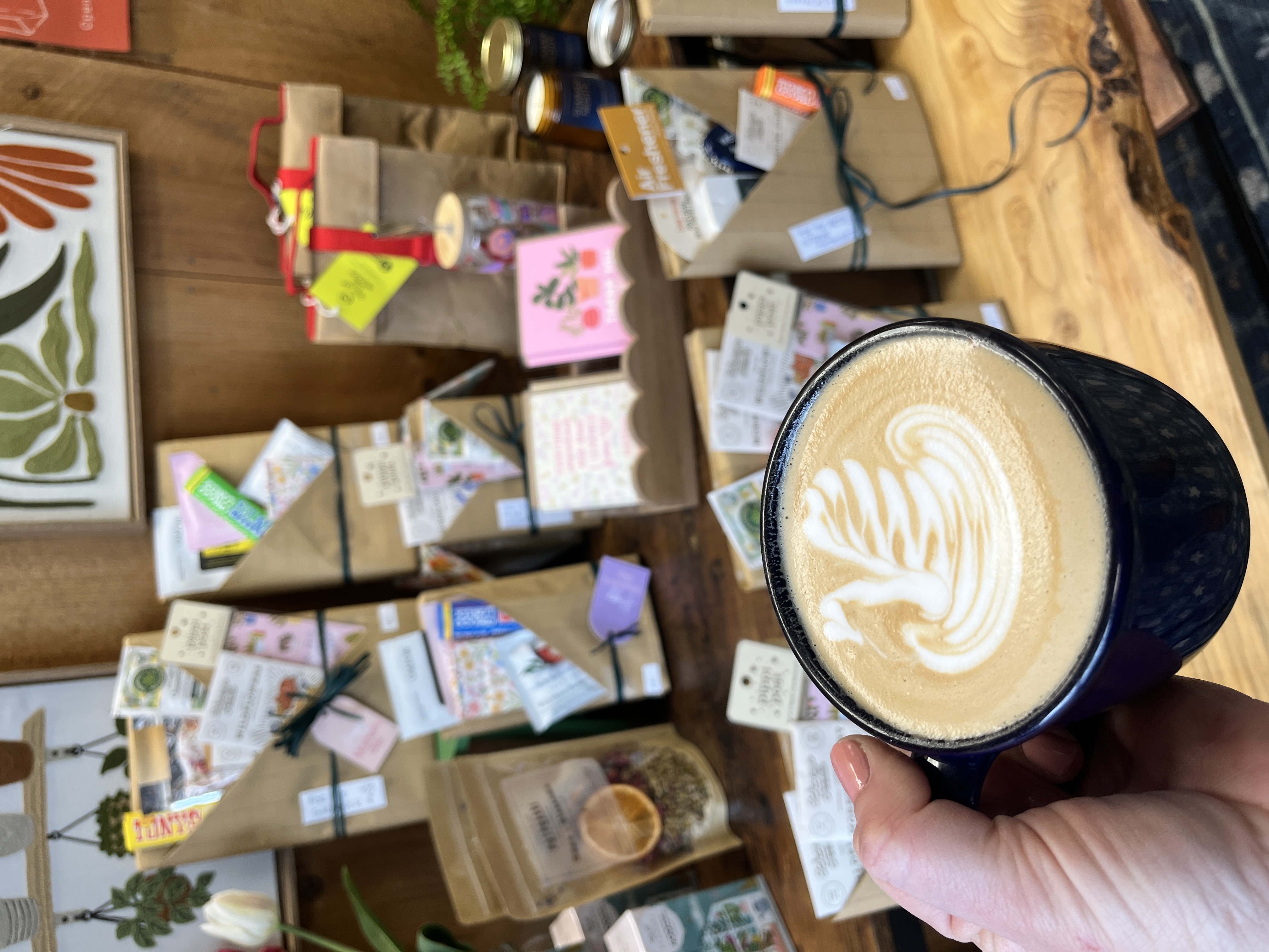 A latte with swan art with thoughtful gift sets of blind date book experiences. 
